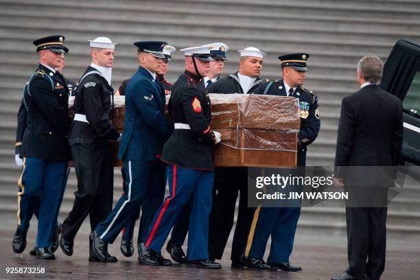 Military Honor Guard carries the casket of Reverend Billy Graham as it departs the US Capitol in Washington, DC, March 1 after a Lying in Honor...