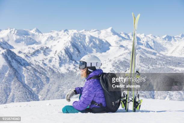 woman with skis looking at the pyrenees mountains in baqueira beret catalonia spain - baqueira beret stock pictures, royalty-free photos & images
