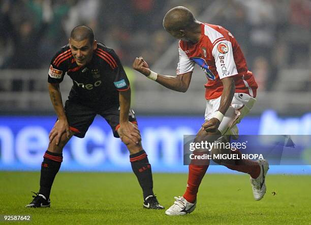 Braga´s Paulo Cesar from Brazil celebrates close to Benfica´s player Maxi Pereira from Uruguay after scoring during their Portuguese league football...