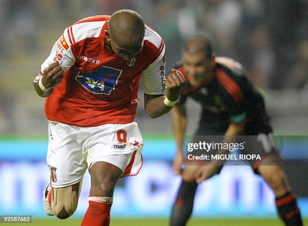 Braga´s Paulo Cesar from Brazil celebrates with Benfica´s player Maxi Pereira from Uruguay after scoring during their Portuguese league football...