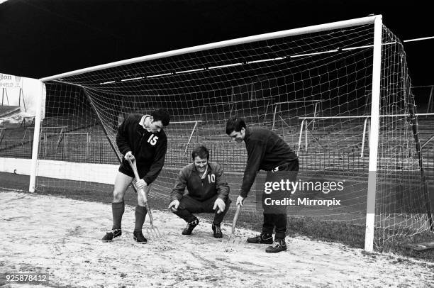 Charlton Athletic team training session at the Valley. Goalkeeper Charlie Wright directs ice clearing operations in the goalmouth as Brian Kinsey and...