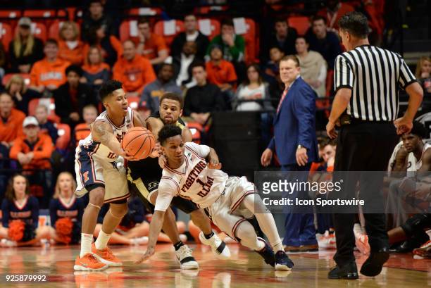 An official looks on as Purdue Boilermakers guard P.J. Thompson gets in between Illinois Fighting Illini guard Te'Jon Lucas and Illinois Fighting...