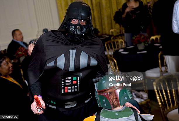Press Secretary Robert Gibbs dressed as Darth Vader and son Ethan dressed as Boba Fett in the east room greets parents, trick-or-treaters and local...