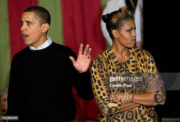 President Barack Obama and first lady Michelle Obama greet parents, trick-or-treaters and local school children at the north portico of the White...