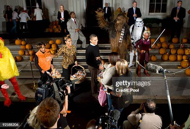 President Barack Obama, first lady Michelle Obama and her mother Marian Robinson greet parents and local school children at the north portico of the...