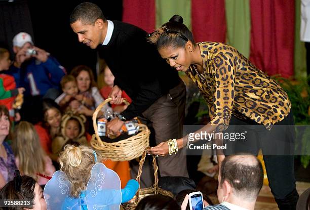 President Barack Obama and first lady Michelle Obama greet parents, trick-or-treaters and local school children at the north portico of the White...