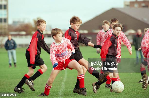 Eston Nab v High Grange , Under 11's football match at Eston Recreation Ground. Shoulder to shoulder the players nudge each other out of the way of...