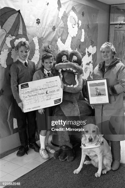 Wellhouse Middle School, Mirfield present a cheque to Guide Dogs for the Blind. Pictured are Richard and Nicola McBride presenting the cheque to...