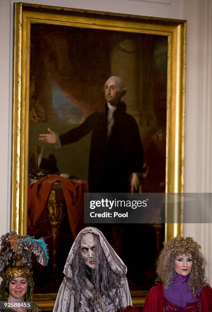 Participants looks on as President Barack Obama and first lady Michelle Obama greet parents, trick-or-treaters and local school children at the White...