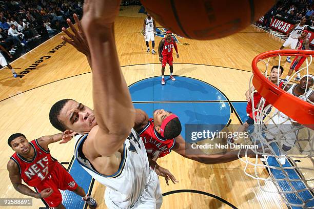 JaVale McGee of the Washington Wizards slam dunks against Sean Williams and Chris Douglas-Roberts of the New Jersey Nets at the Verizon Center during...