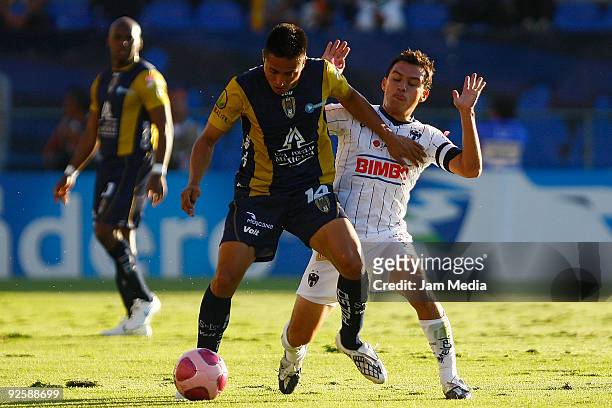 Noe Maya of San Luis vies for the ball with Luis Ernesto Perez of Monterrey during their match as part of the Opening Tournament in the Mexican...