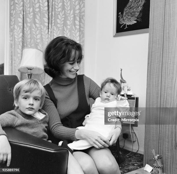 Olga Fullaway, mother of two, aged 31, pictured with children, sons Stephen and David , 19th October 1970. Olga has recently started work as...