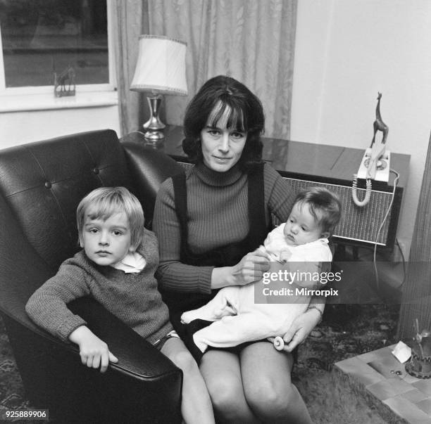 Olga Fullaway, mother of two, aged 31, pictured with children, sons Stephen and David , 19th October 1970. Olga has recently started work as...