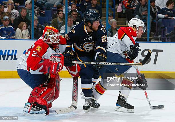 Tomas Vokoun and Keith Ballard of the Florida Panthers defend against Yan Stastny of the St. Louis Blues on October 31, 2009 at Scottrade Center in...