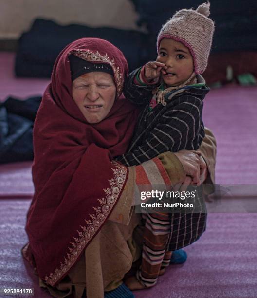 Displaced Kashmiris take shelter in a government school during a fresh skirmish along the border on February 27, 2018 in Uri, 120 Kms north west of...