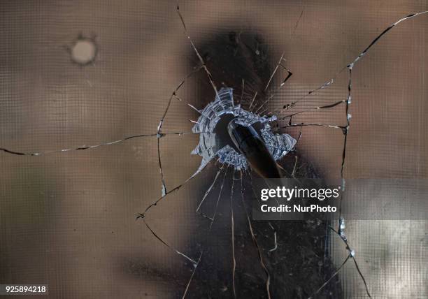 Man is seen through the bullet pierced glass during a fresh skirmish along the border on February 27, 2018 in Uri, 120 Kms north west of Srinagar ,...