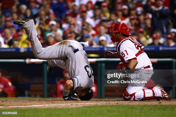 Nick Swisher of the New York Yankees collides with Carlos Ruiz of the Philadelphia Phillies as he scores in the top of the fifth inning in Game Three...