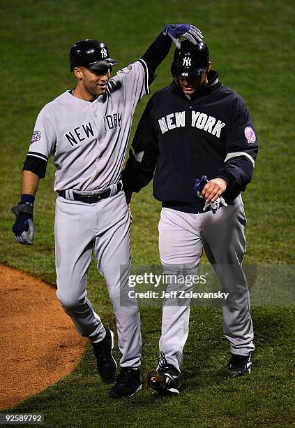 Derek Jeter of the New York Yankees celebrates scoring in the fifth inning on a Johnny Damon double with Andy Pettitte against the Philadelphia...