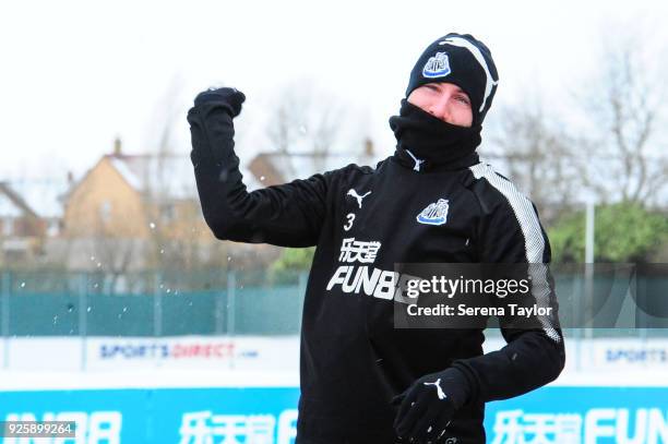 Paul Dummett throws a snowball as he walks outside during the Newcastle United Training Session at the Newcastle United Training Centre on March 1 in...