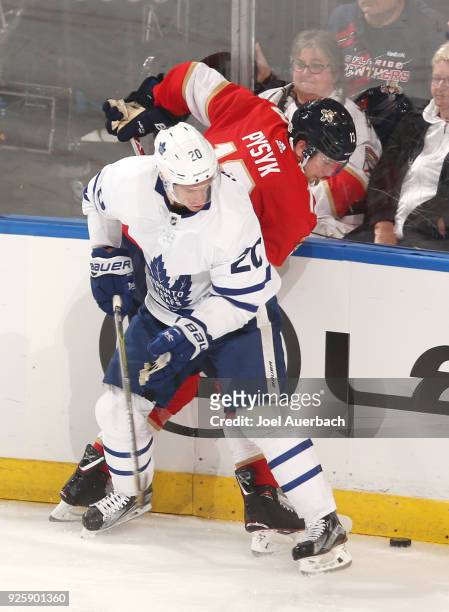 Dominic Moore of the Toronto Maple Leafs checks Mark Pysyk of the Florida Panthers off the puck during third period action at the BB&T Center on...