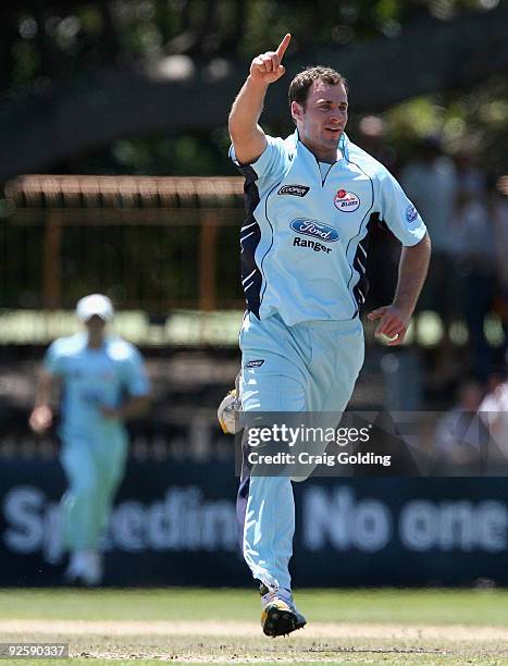 Burt Cockley of the the Blues celebrates after taking the wicket of Luke Ronchi during the Ford Ranger Cup match between the New South Wales Blues...
