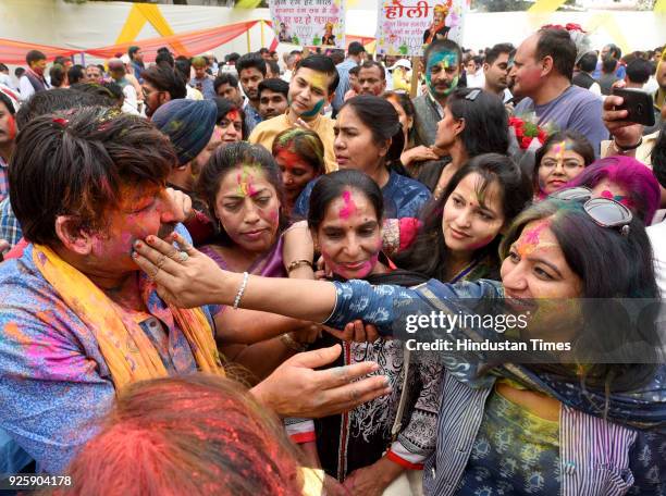 Delhi BJP President Manoj Tiwari with Delhi BJP Mahila Morcha President Poonam Parashar and other workers celebrate Holi during the Holi Milan...