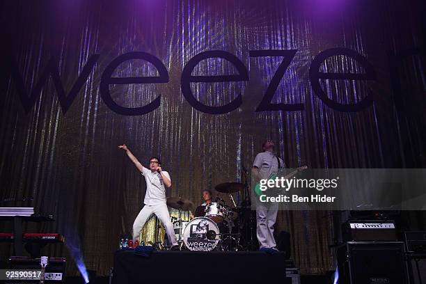 Singer Rivers Cuomo, drummer Scott Shriner and Guitarist Pat Wilson of Weezer perform at the MetroPCS Masquerade at Hammerstein Ballroom on October...