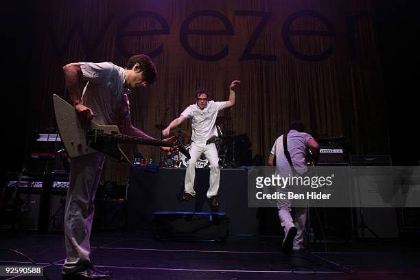 Guitarist Brian Bell, Singer Rivers Cuomo and bassist Mikey Welsh of Weezer performs at the MetroPCS Masquerade at Hammerstein Ballroom on October...