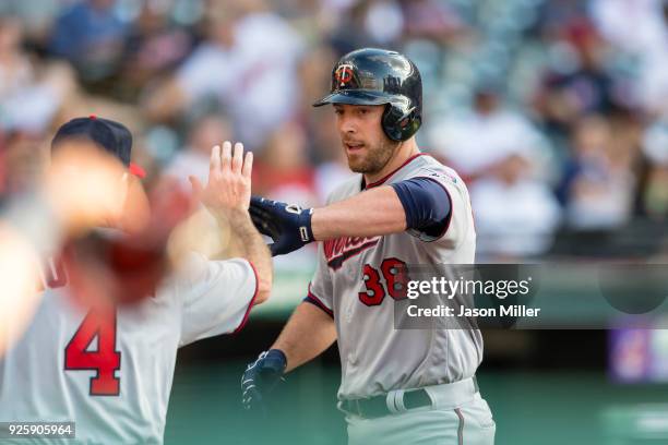 Chris Gimenez of the Minnesota Twins celebrates after scoring on a home run during the ninth inning against the Cleveland Indians at Progressive...