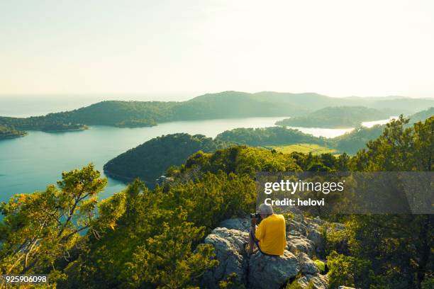 men photographing island mljet - lagoon forest stock pictures, royalty-free photos & images