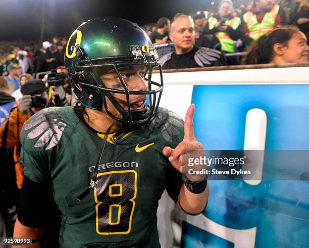 Quarterback Jeremiah Masoli of the Oregon Ducks celebrates with fans on the sidelines as time runs down in the fourth quarter of the game against the...