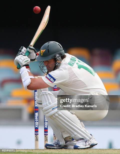 Tim McDonald of the Tigers ducks under a bouncer during day one of the Sheffield Shield match between the Queensland Bulls and the Tasmanian Tigers...