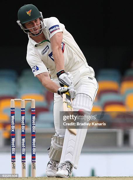 Brendan Drew of the Tigers hits a six during day one of the Sheffield Shield match between the Queensland Bulls and the Tasmanian Tigers at The Gabba...
