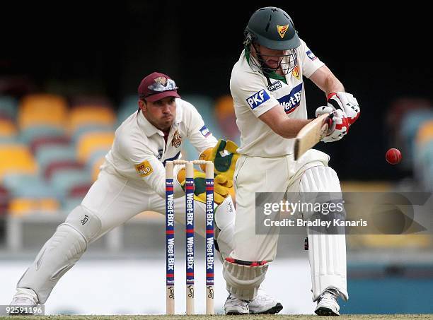 Brady Jones of the Tigers plays a shot during day one of the Sheffield Shield match between the Queensland Bulls and the Tasmanian Tigers at The...
