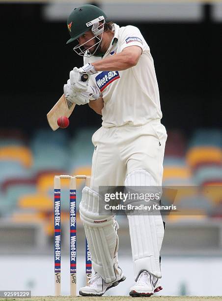 Brett Geeves of the Tigers guides the ball past the wicketkeeper during day one of the Sheffield Shield match between the Queensland Bulls and the...