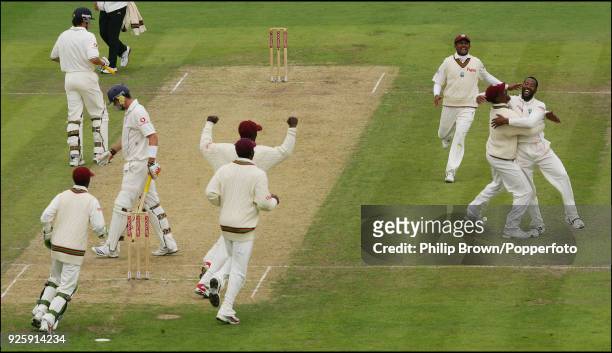 West Indies bowler Corey Collymore celebrates with teammate Runako Morton after taking the wicket of England batsman Kevin Pietersen for 9 runs...