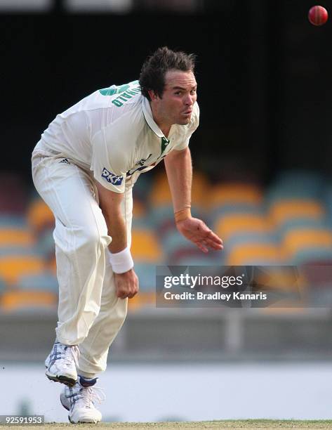 Tim McDonald of the Tigers bowls during day one of the Sheffield Shield match between the Queensland Bulls and the Tasmanian Tigers at The Gabba on...