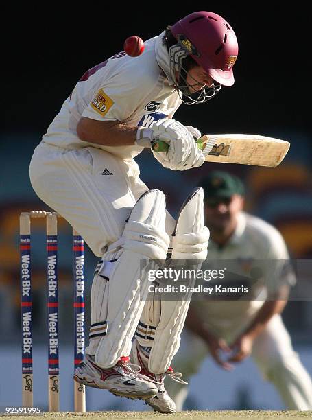 Ryan Broad of the Bulls attempts to avoid a bouncer during day one of the Sheffield Shield match between the Queensland Bulls and the Tasmanian...