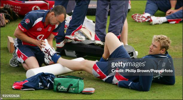 Andrew Flintoff of England has his ankle massaged by team massage therapist Mark Saxby during a training session before the 6th NatWest Series One...