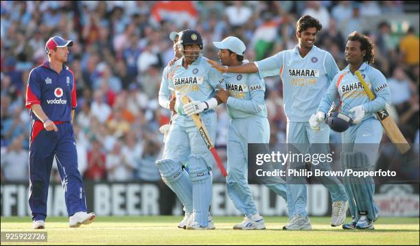 India's not out batsmen Robin Uthappa and Ramesh Powar are congratulated by teammates as they leave the field after winning the 6th NatWest Series...