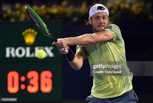 Lucas Pouille of France plays a backhand during his quarter final match against Yuichi Sugita of Japan on day four of the ATP Dubai Duty Free Tennis...