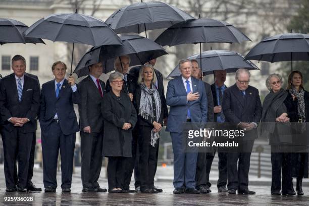 Family and guests watch the casket of American evangelist Billy Graham exit the East Steps at the US Capitol in Washington, United States on March...