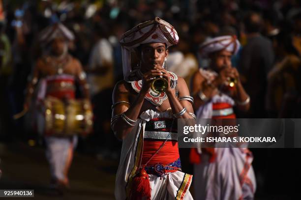 Sri Lankan traditional Kandyan dancers perform during a procession in front of The Gangarama Temple in Colombo on March 1 during The Navam Perahera...