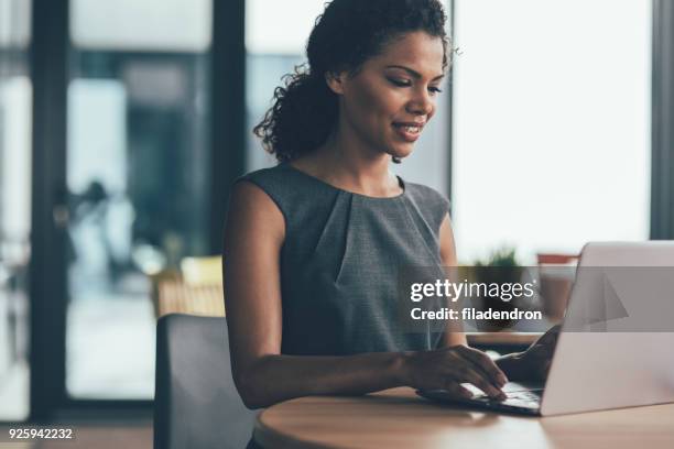confidence and success in business - female power suit stock pictures, royalty-free photos & images