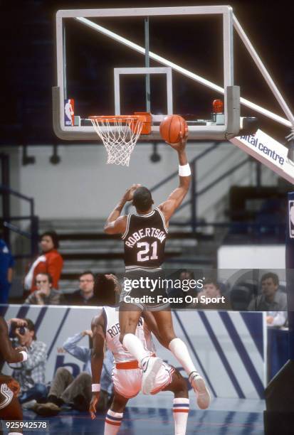 Alvin Robertson of the San Antonio Spurs shoots over Cliff Robinson of the Washington Bullets during an NBA basketball game circa 1985 at the Capital...