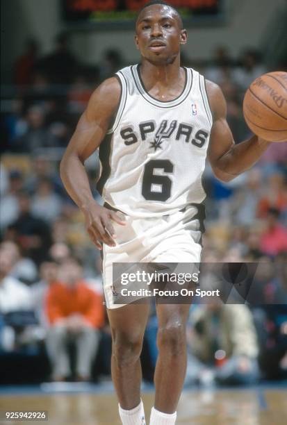 Avery Johnson of the San Antonio Spurs dribbles the ball up court during an NBA basketball game circa 1992 at the HemisFair Arena in San Antonio,...