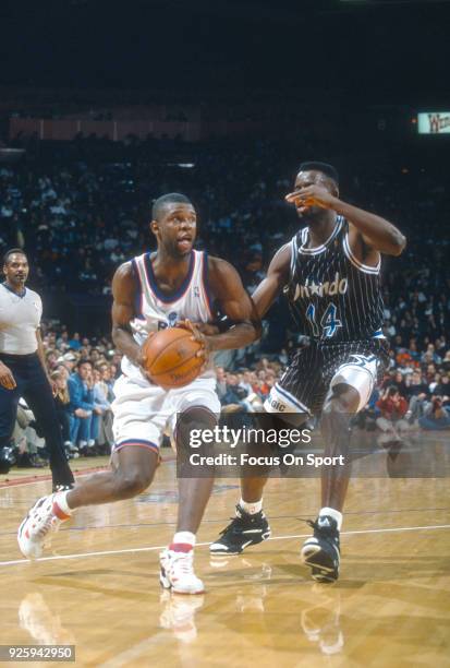 Calbert Cheaney of the Washington Bullets drives on Anthony Bowie of the Orlando Magic during an NBA basketball game circa 1994 at the US Airways...