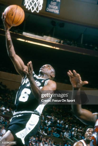 Avery Johnson of the San Antonio Spurs goes in for a layup against the New York Knicks during an NBA basketball game circa 1993 at Madison Square...