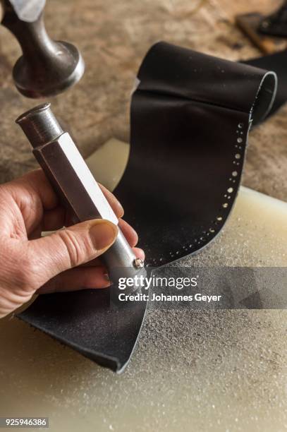 shoemaker, patterns are punched in side part with hole punch and hammer, unterneath impact plate, kainisch, styria, austria - hole punch stock pictures, royalty-free photos & images