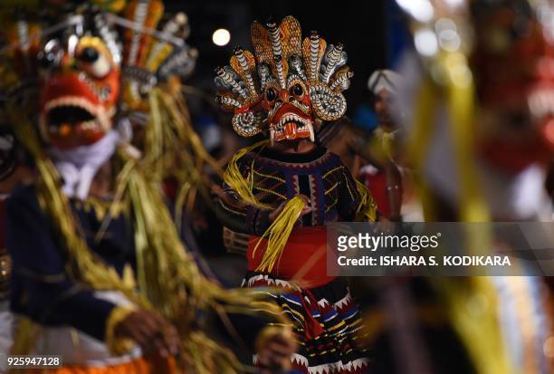 Sri Lankan traditional Kandyan dancers perform during a procession in front of The Gangarama Temple in Colombo on March 1 during The Navam Perahera...